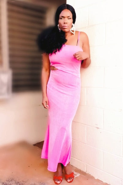 a woman in a pink dress holding a skateboard