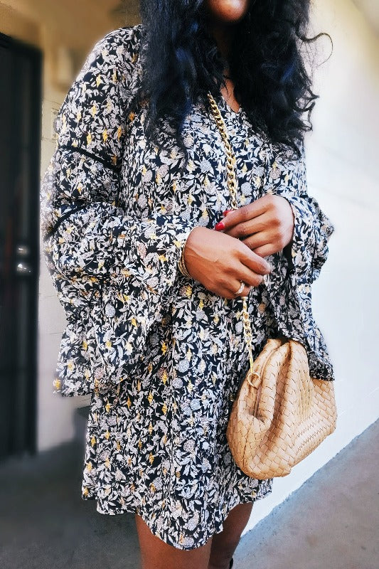 a woman holding a suitcase and a backpack