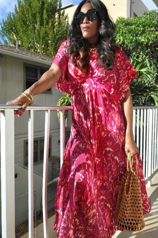 a woman in a red dress holding a cell phone