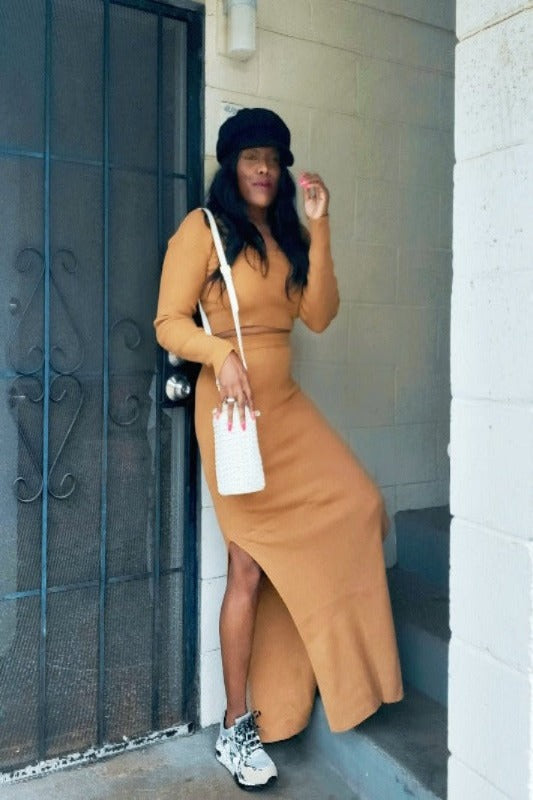 a woman in a dress is talking on a cell phone