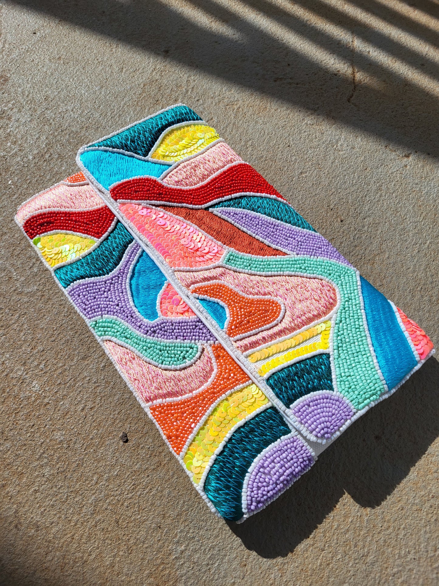 a pink and blue striped tie sitting on the floor