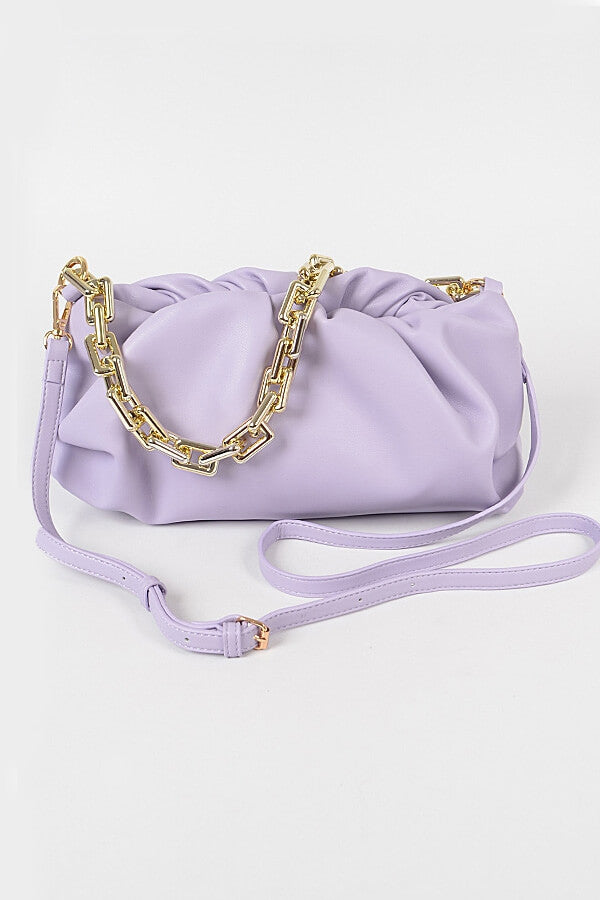 a purse and a bag on a white surface
