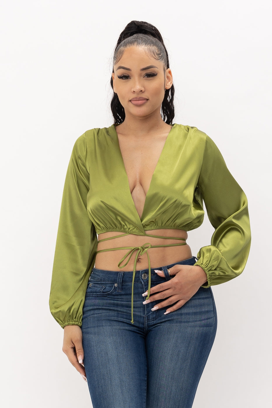 a woman in a green shirt holding a cell phone