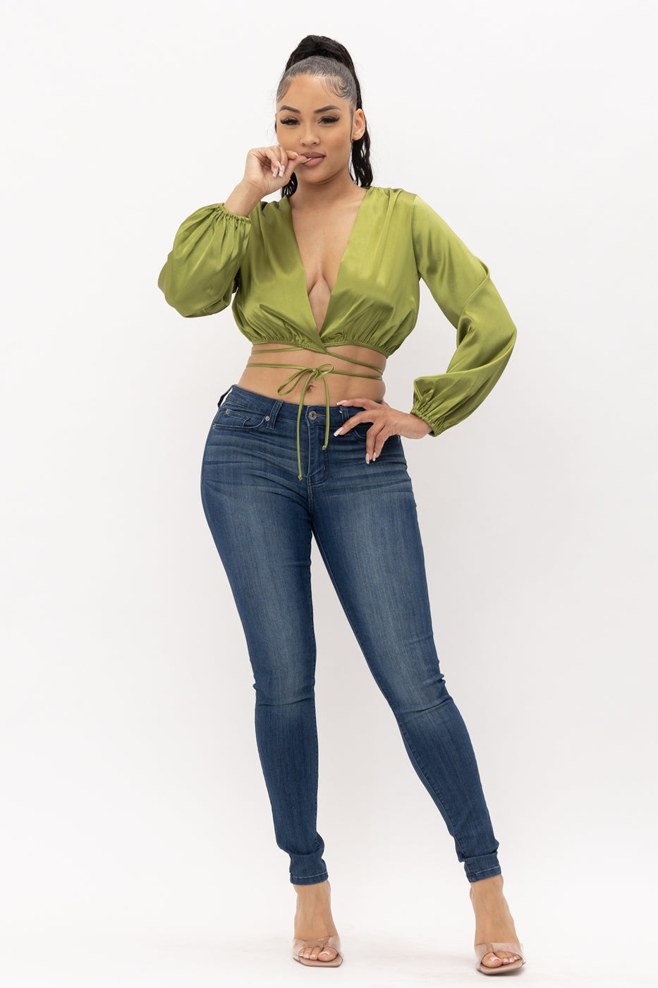 a woman in a green shirt on a cell phone