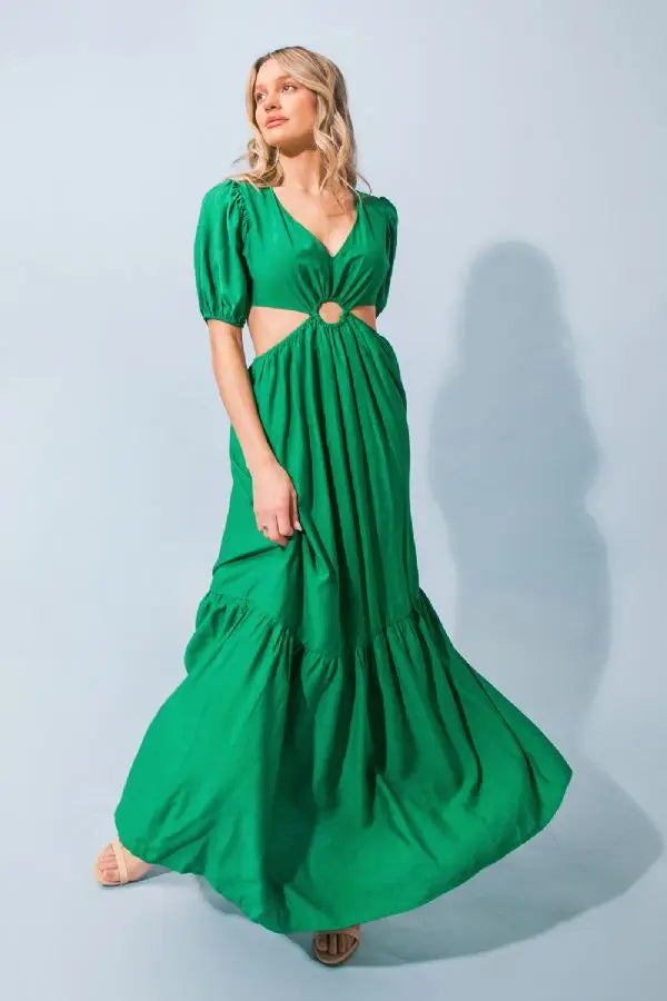 a woman in a green dress holding a green umbrella