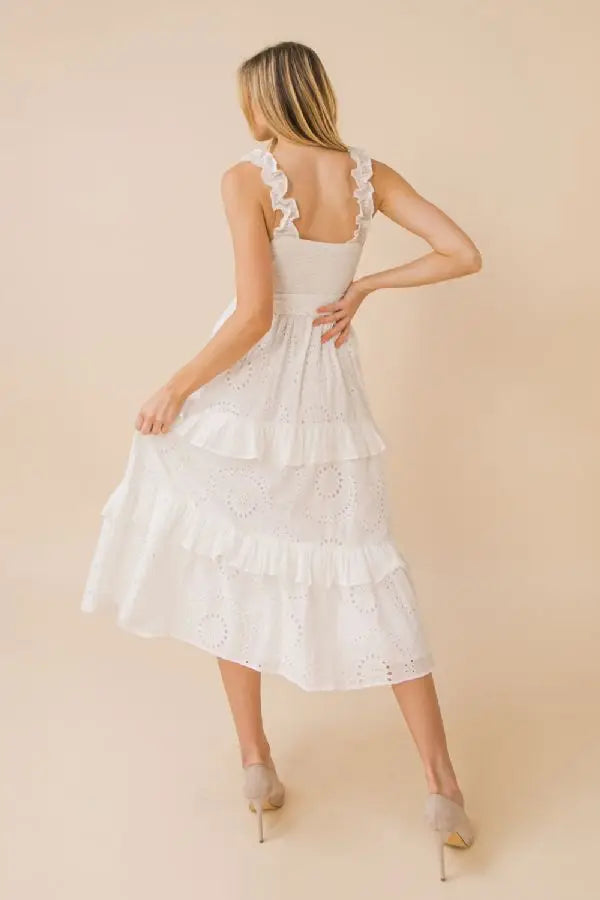 a woman in a dress holding a hair dryer