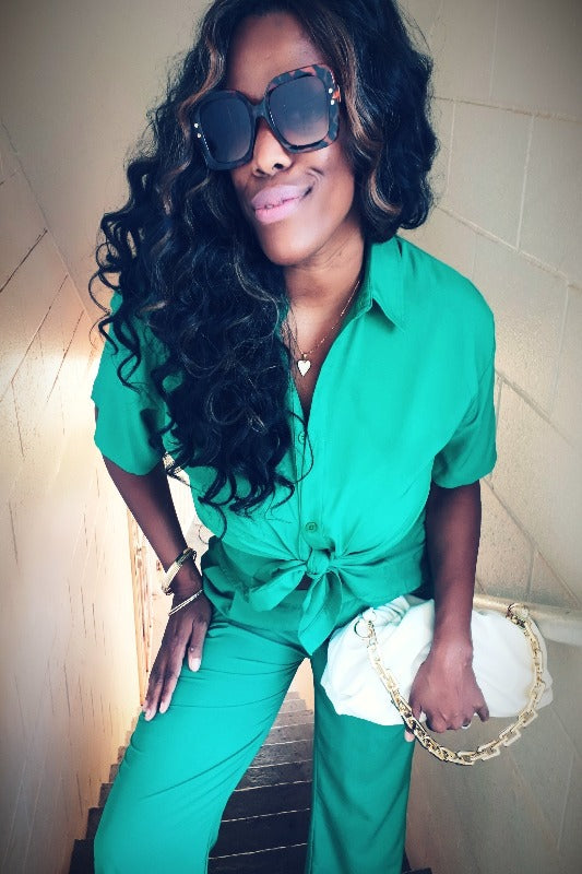 a woman in glasses and a green sweater and glasses