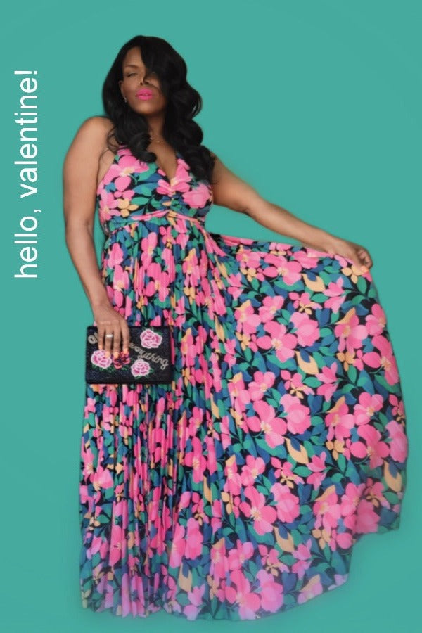 a woman in a floral dress standing in a room