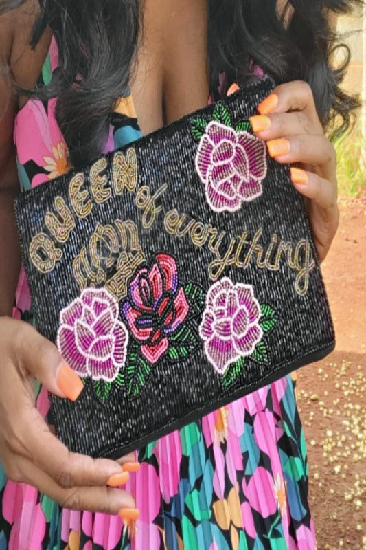 a person holding a pink and black bag 