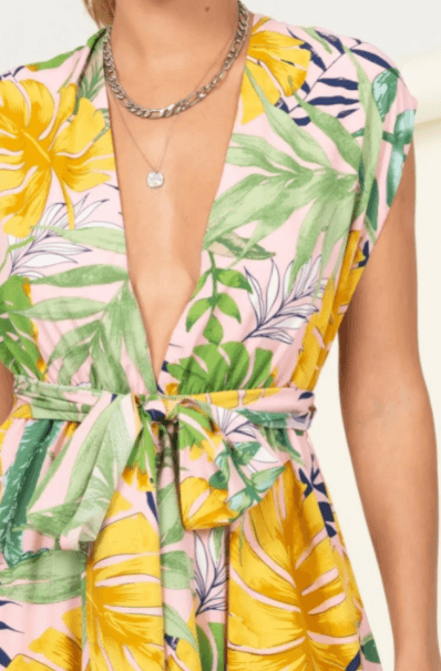 a woman in a yellow dress holding a flower