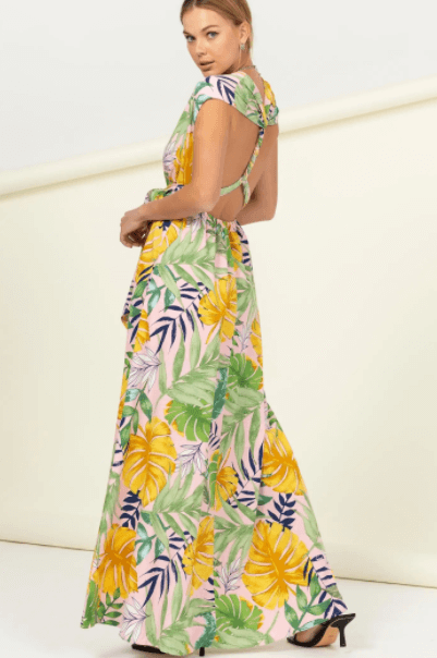 a woman in a colorful dress holding a skateboard