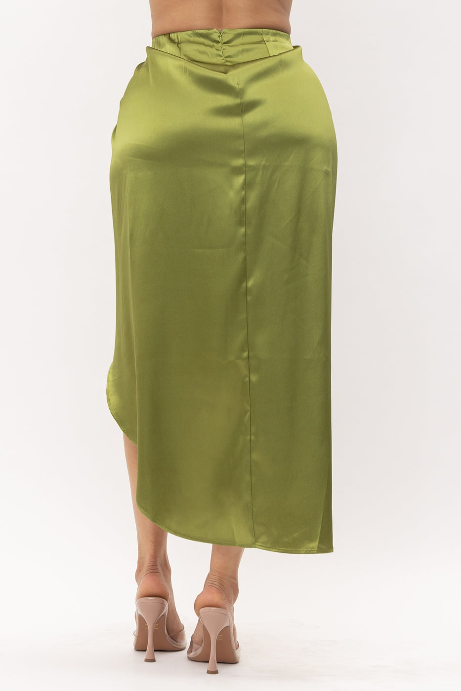 a woman in a green dress standing in the snow