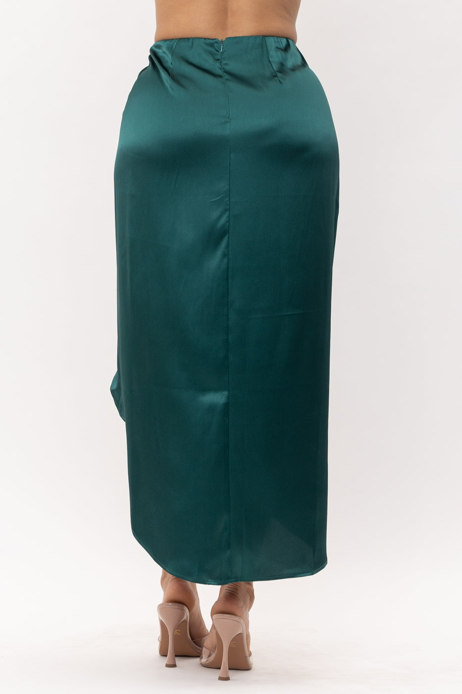 a man in a green coat holding a suitcase