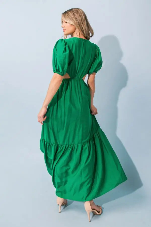 a woman in a green outfit holding a snowboard