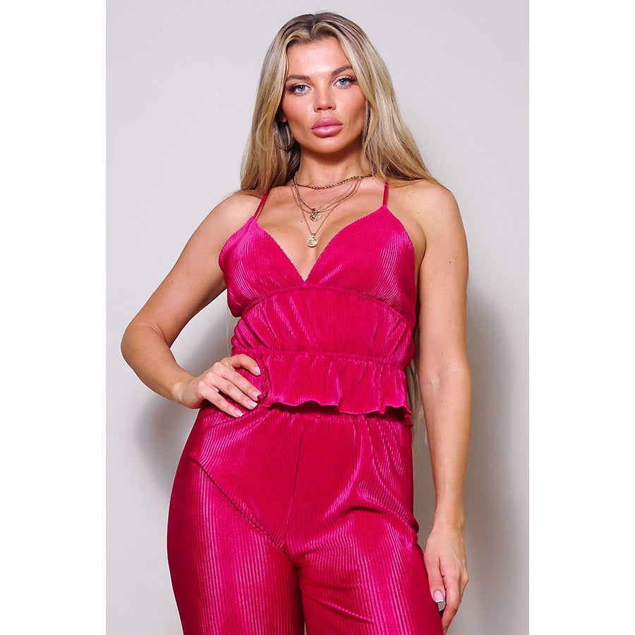 a woman in a pink dress poses for a picture