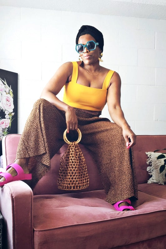 a woman in a dress sitting on a couch 