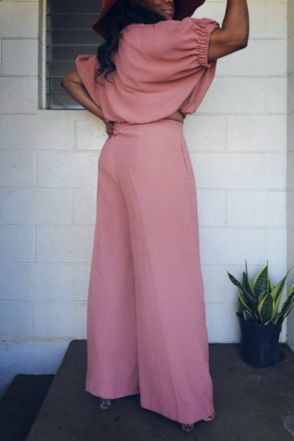 a girl in a pink dress holding a cell phone 